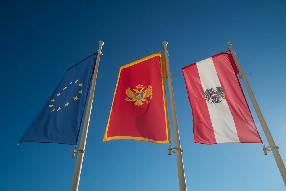 2026-06-12_perast_three-flags-against-sky_dsc06294.jpg